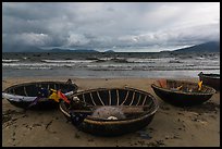 Coracle boats on beach during storm. Da Nang, Vietnam (color)