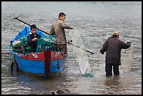 Men operating fish traps. Vietnam (color)