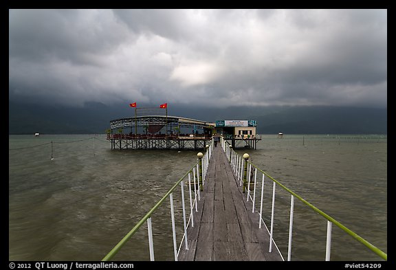 Pier leading to restaurant on stilts. Vietnam