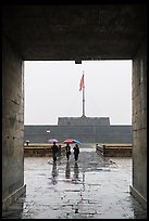 Tourists with unbrellas and flag monument, citadel. Hue, Vietnam ( color)