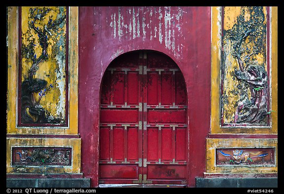 Red door and ceramic decorations, imperial citadel. Hue, Vietnam