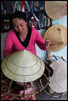Woman crafting conical hat. Hue, Vietnam (color)