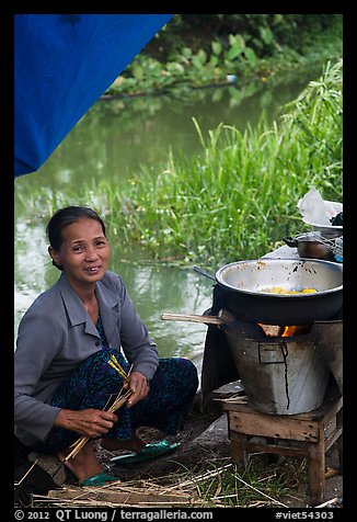 Woman cooking canalside, Thanh Toan. Hue, Vietnam (color)