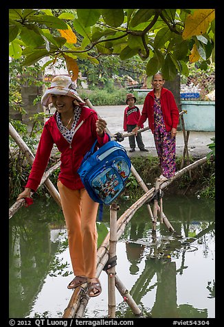Women crossing monkey bridge, Thanh Toan. Hue, Vietnam (color)