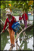 Women crossing monkey bridge, Thanh Toan. Hue, Vietnam (color)