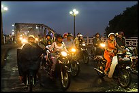 Mtorcylists by night, Trang Tien Bridge. Hue, Vietnam (color)