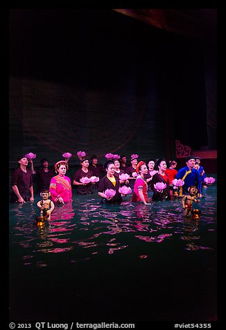 Water puppet artists receiving applause in pool after performance, Thang Long Theatre. Hanoi, Vietnam