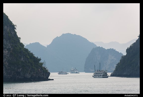 Tour boats and islands in mist. Halong Bay, Vietnam (color)