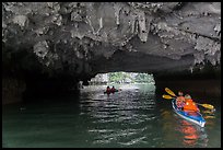 Paddling through Luon Cave tunnel. Halong Bay, Vietnam (color)