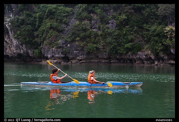 Sea kayakers on emerald waters. Halong Bay, Vietnam