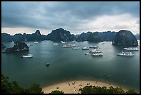 Crescent beach, boats and karst, Titov Island. Halong Bay, Vietnam (color)