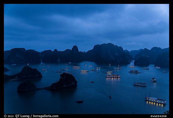 Tour boats lights and islands from above at night. Halong Bay, Vietnam