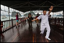 Morning Tai Chi session on tour boat deck. Halong Bay, Vietnam ( color)