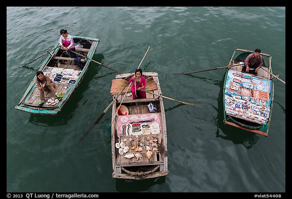 Women selling sea shells and perls from row boats. Halong Bay, Vietnam