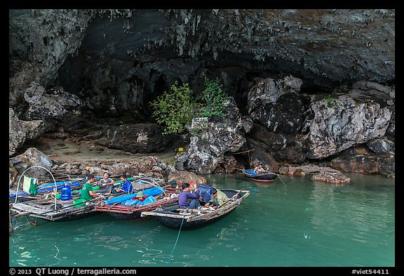 Fishermen anchor eating breakfast in cave. Halong Bay, Vietnam