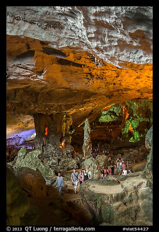 Tourists walking in cavernous chamber, Sungsot cave. Halong Bay, Vietnam