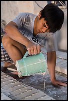 Man pouring clay into molds in ceramic workshop. Bat Trang, Vietnam (color)
