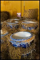 Ceramic vases wrapped in hay in storeroom. Bat Trang, Vietnam (color)