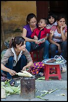 Woman roasting corn in the street. Bat Trang, Vietnam (color)