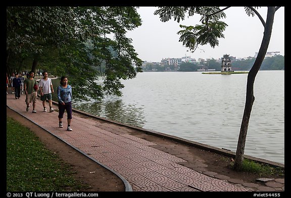 Walking for exercise around Hoang Kiem Lake at dawn. Hanoi, Vietnam