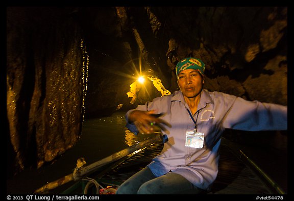 Woman boater in narrow cave passage, Trang An. Ninh Binh,  Vietnam