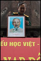 Officer hanging a picture of Ho Chi Minh, Hanoi Citadel. Hanoi, Vietnam ( color)