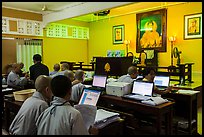 Monks working on computers, An Quang Pagoda, district 10. Ho Chi Minh City, Vietnam (color)