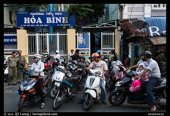 Parents waiting to pick up children in front of school. Ho Chi Minh City, Vietnam