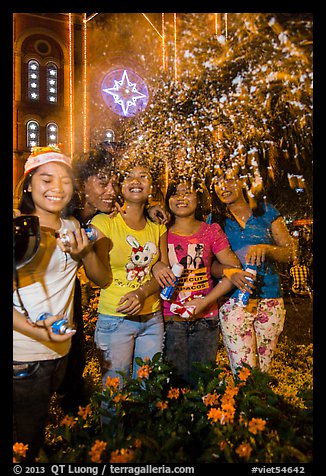 Young Revellers in front of Notre Dame Cathedral on Christmas Eve. Ho Chi Minh City, Vietnam (color)