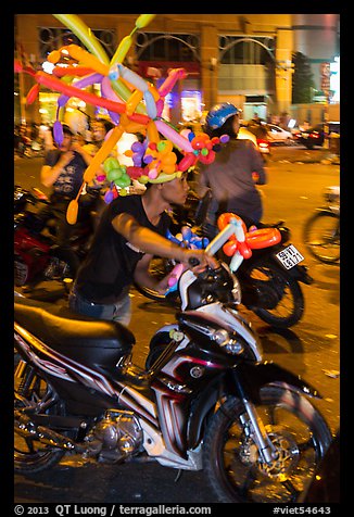 Man with coiffe of balloons, Christmas Eve. Ho Chi Minh City, Vietnam