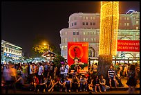 Revellers sitting on street, New Year eve. Ho Chi Minh City, Vietnam (color)