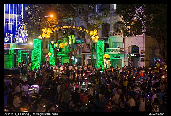 Crowds on street at night, New Year eve. Ho Chi Minh City, Vietnam