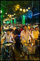 Street packed with motorbikes and bicycle riders at night. Ho Chi Minh City, Vietnam (color)