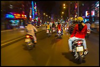 Riders view of motorcycle traffic at night. Ho Chi Minh City, Vietnam (color)