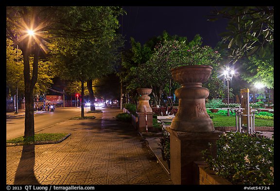 Sidewalk and park at night. Ho Chi Minh City, Vietnam