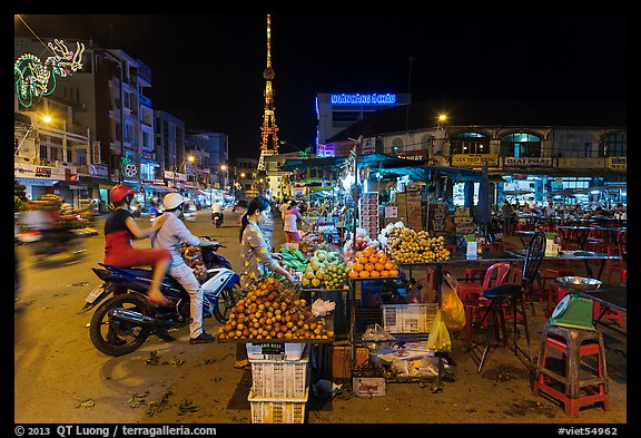 Street market and telecomunication tower at night. Tra Vinh, Vietnam