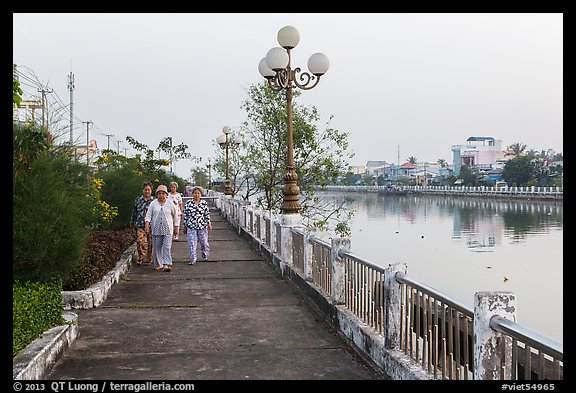 Elderly women strolling on riverfront. Tra Vinh, Vietnam