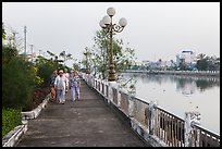 Elderly women strolling on riverfront. Tra Vinh, Vietnam (color)
