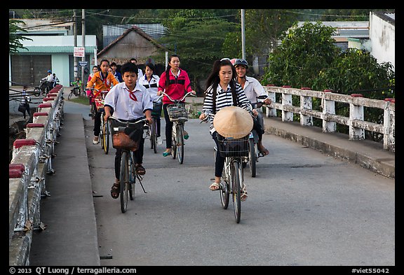 Children bike on way to school, Phung Diem. Can Tho, Vietnam