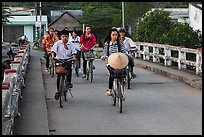 Children bike on way to school, Phung Diem. Can Tho, Vietnam (color)