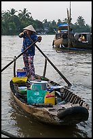 Woman paddles boat with pho noodles, Phung Diem. Can Tho, Vietnam (color)