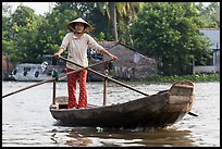 Woman using the distinctive x-shape paddle. Can Tho, Vietnam (color)