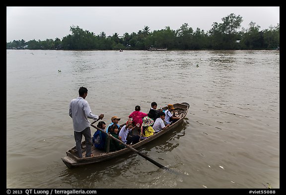 Schoolchildren crossing river on boat. Can Tho, Vietnam