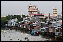 Riverside houses on stilts and Cao Dai temple. Mekong Delta, Vietnam ( color)