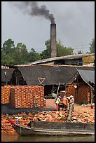 Workers moving bricks in brick factory. Sa Dec, Vietnam (color)