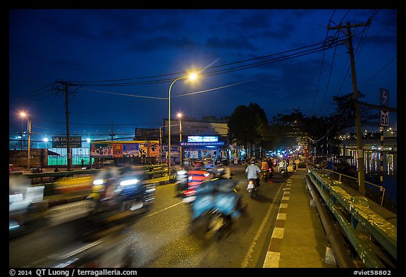 Evening traffic by the canal, District 8. Ho Chi Minh City, Vietnam (color)