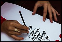 Feminine hand draws Lunar New Year greetings in fancy writing. Ho Chi Minh City, Vietnam ( color)
