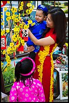 Woman and children in traditional dress for lunar new year. Ho Chi Minh City, Vietnam ( color)