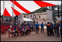 Uniformed young men and women gather for lunar new year. Ho Chi Minh City, Vietnam ( color)