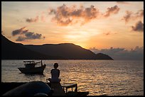 Silhouetted woman watching sunrise from Wharf 914, Con Son. Con Dao Islands, Vietnam ( color)
